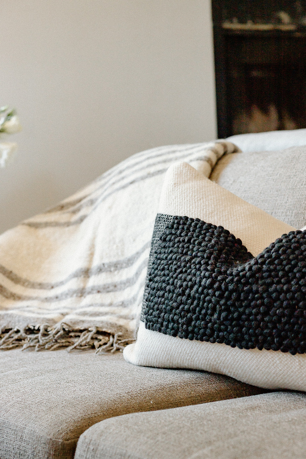 The Cruz Pillow features a natural colored flat weave mixed with a wide contrast stripe of black textured loops. Ethically produced and hand woven by talented artisans in India.