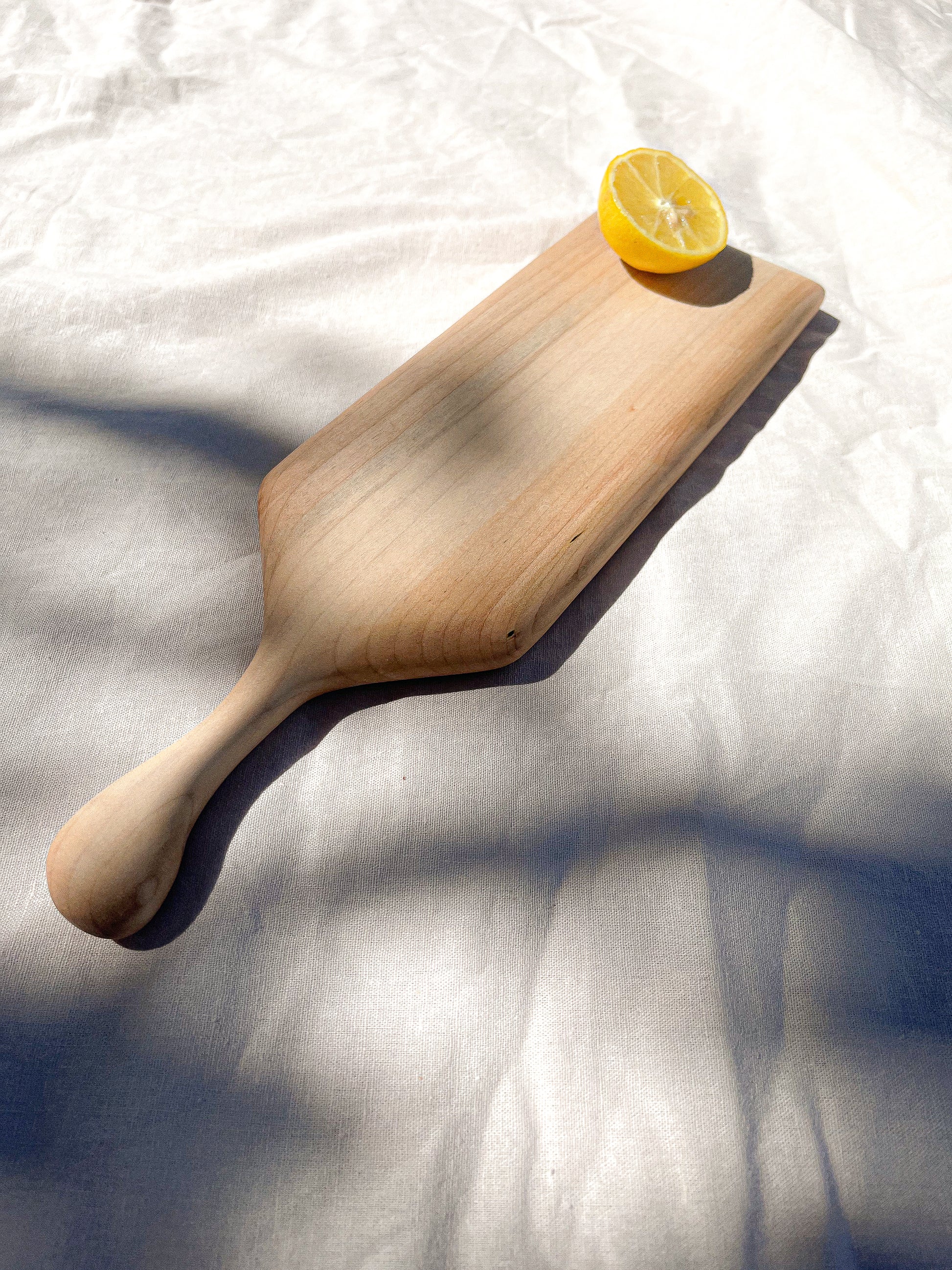 Hand-crafted cheeseboard perfect for a small sampling of cheese or appetizers. The handle is perfect for carrying to the table, and adds visual interest. Made sustainably from maple wood in Gatineau, Canada.