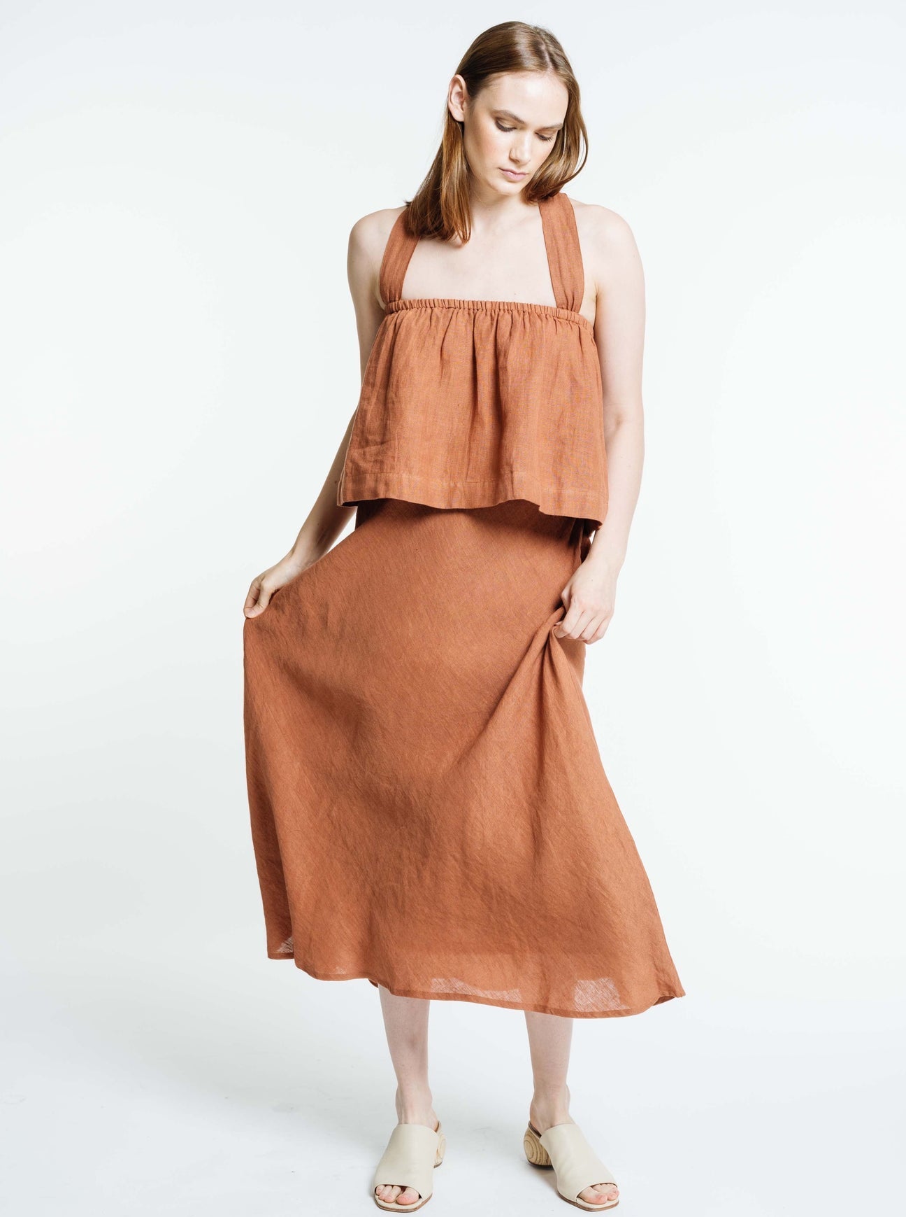 Jardin Midi Skirt: A vintage-inspired skirt with a subtle, feminine a-line shape and sweeping midi-length hemline met with a tailored waistband. Pair it with your favorite tanks and tops for a look that channels our favorite 90s fashion muses. Ethically made in India by Laude the Label.