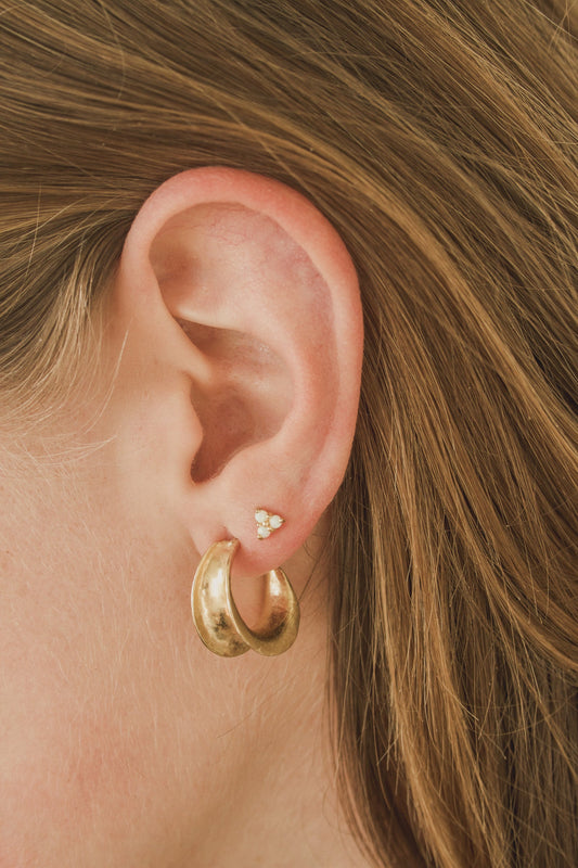 A sparkling opal stud earring with triple set stones. Handmade in the Santa Cruz Mountains.