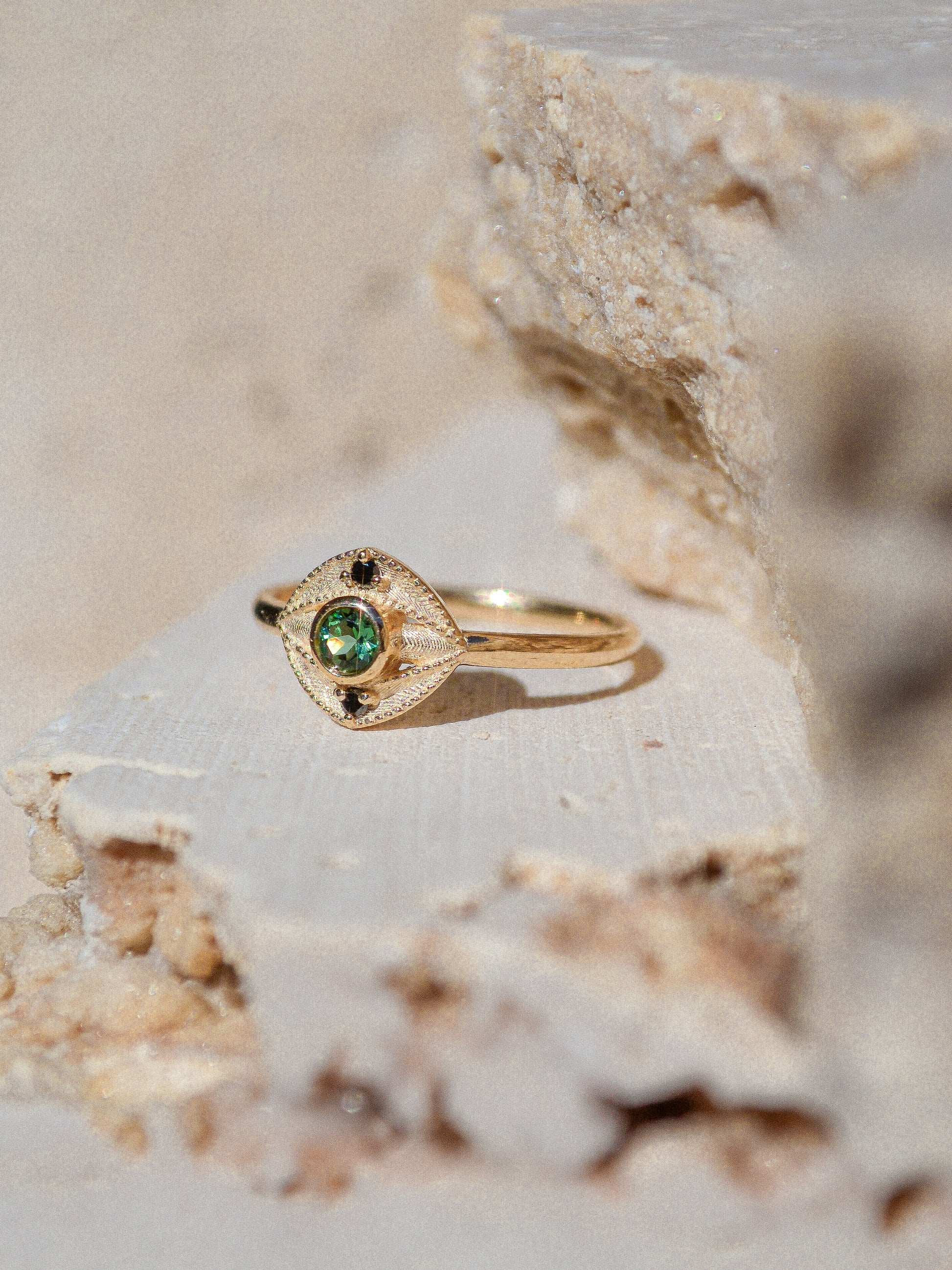 Blue green tourmaline encompassed in an eye shape of solid 14k yellow gold and 2 white diamonds. Inspired by an island in western Scotland. Each Miarante piece is carefully handcrafted in Chicago by a skilled production team.