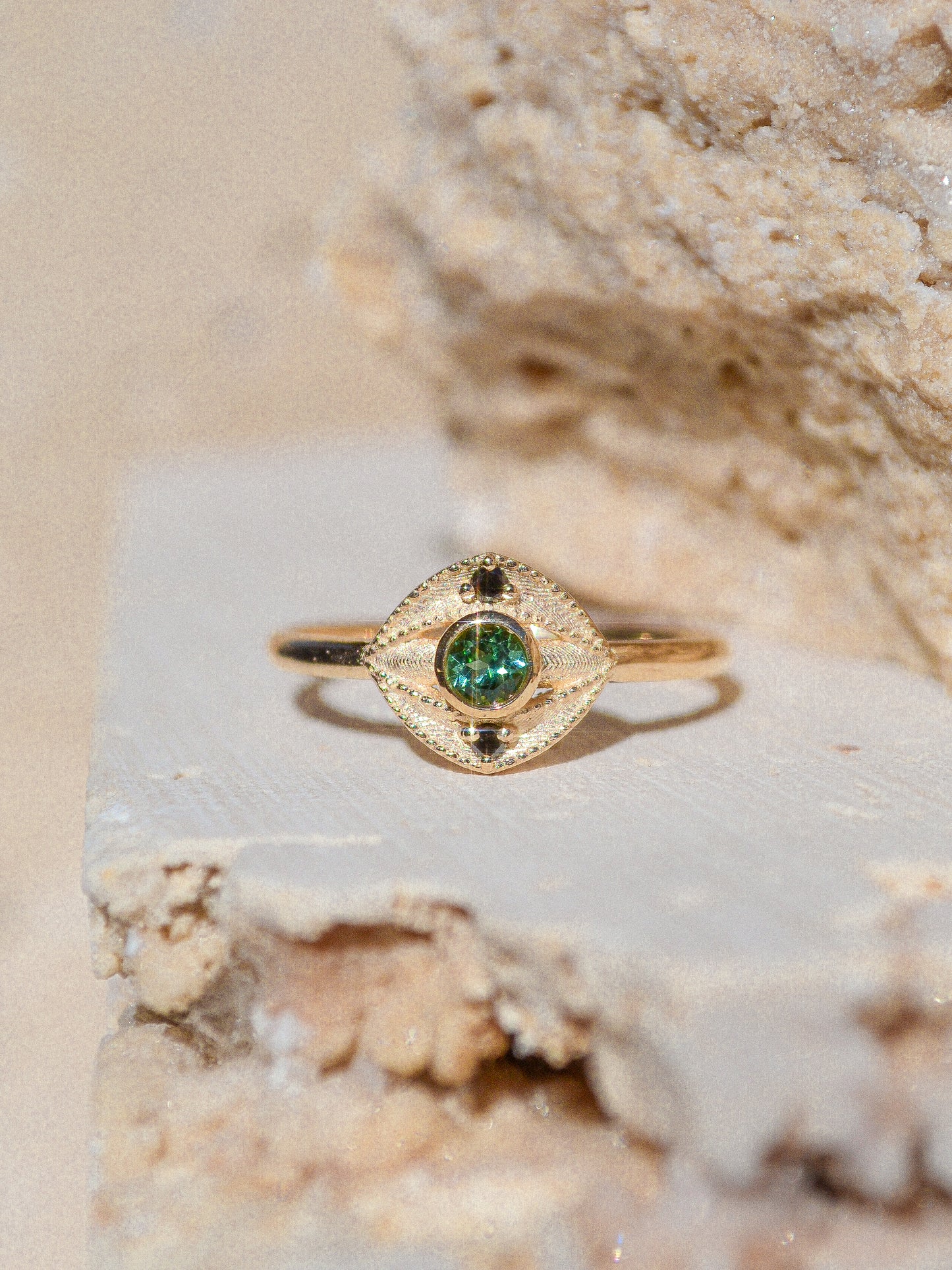 Blue green tourmaline encompassed in an eye shape of solid 14k yellow gold and 2 white diamonds. Inspired by an island in western Scotland. Each Miarante piece is carefully handcrafted in Chicago by a skilled production team.