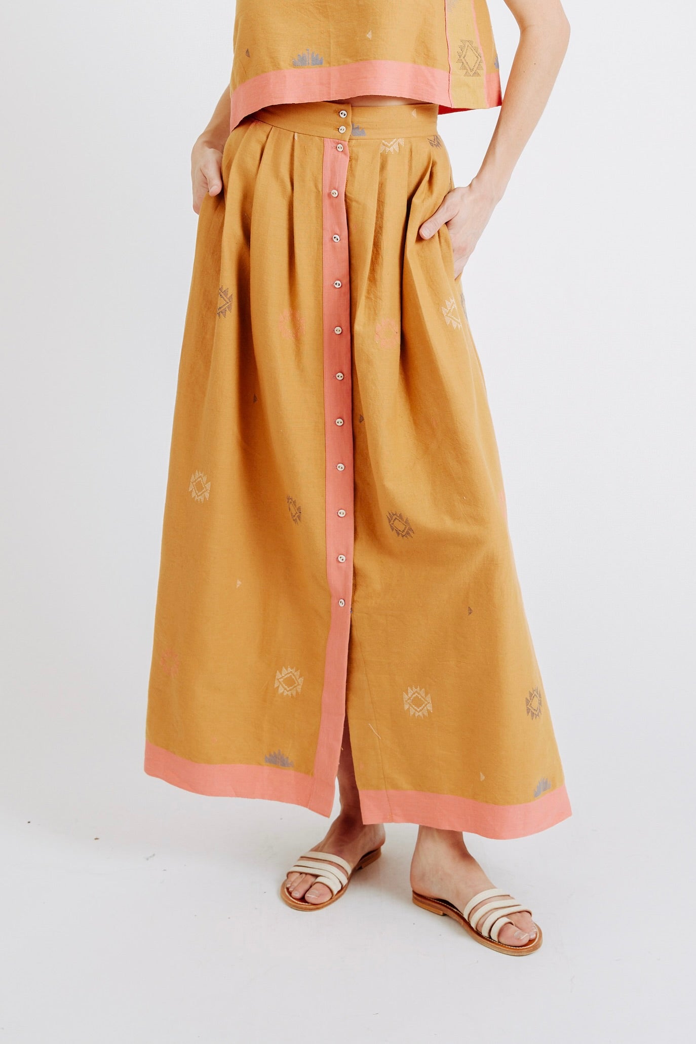 A statement maxi skirt for transitioning to warmer temps featuring jamdani, a weaving technique native to West Bengal. Ethically made with 100% cotton in India.
