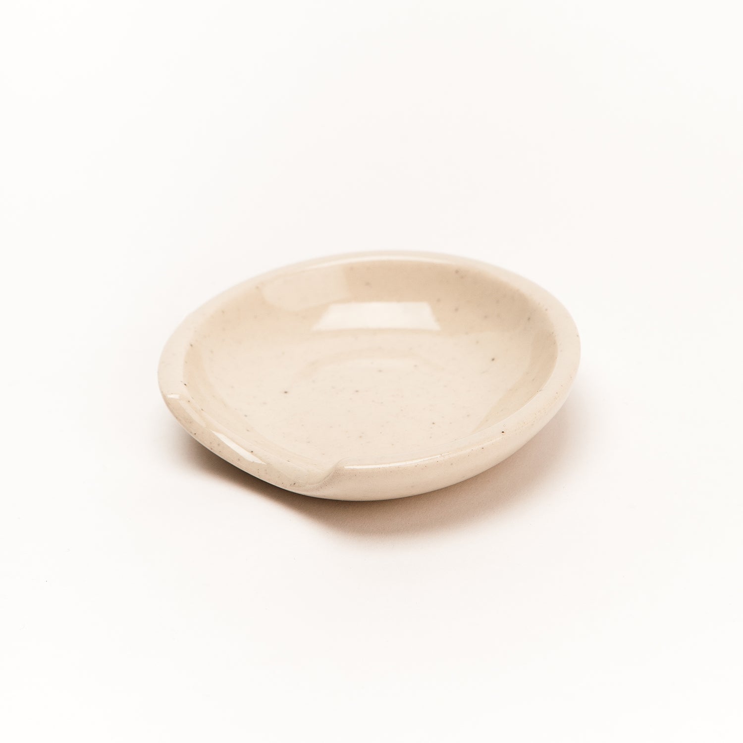A porcelain spoon rest with a unique cut-out side perfectly cradles all shapes and sizes of kitchen tools with minimalist flair. 
