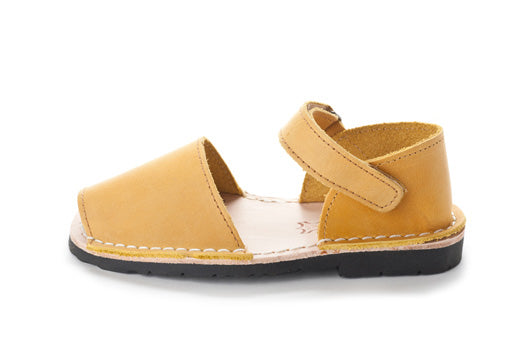Quick to become your favorite pair to slip on your kids feet, these sandals can go with any outfit and go anywhere, anytime! Lovingly handcrafted by local artisans from Menorca, Spain with all natural high quality leather. Kids Pons Sandals in Saffron.