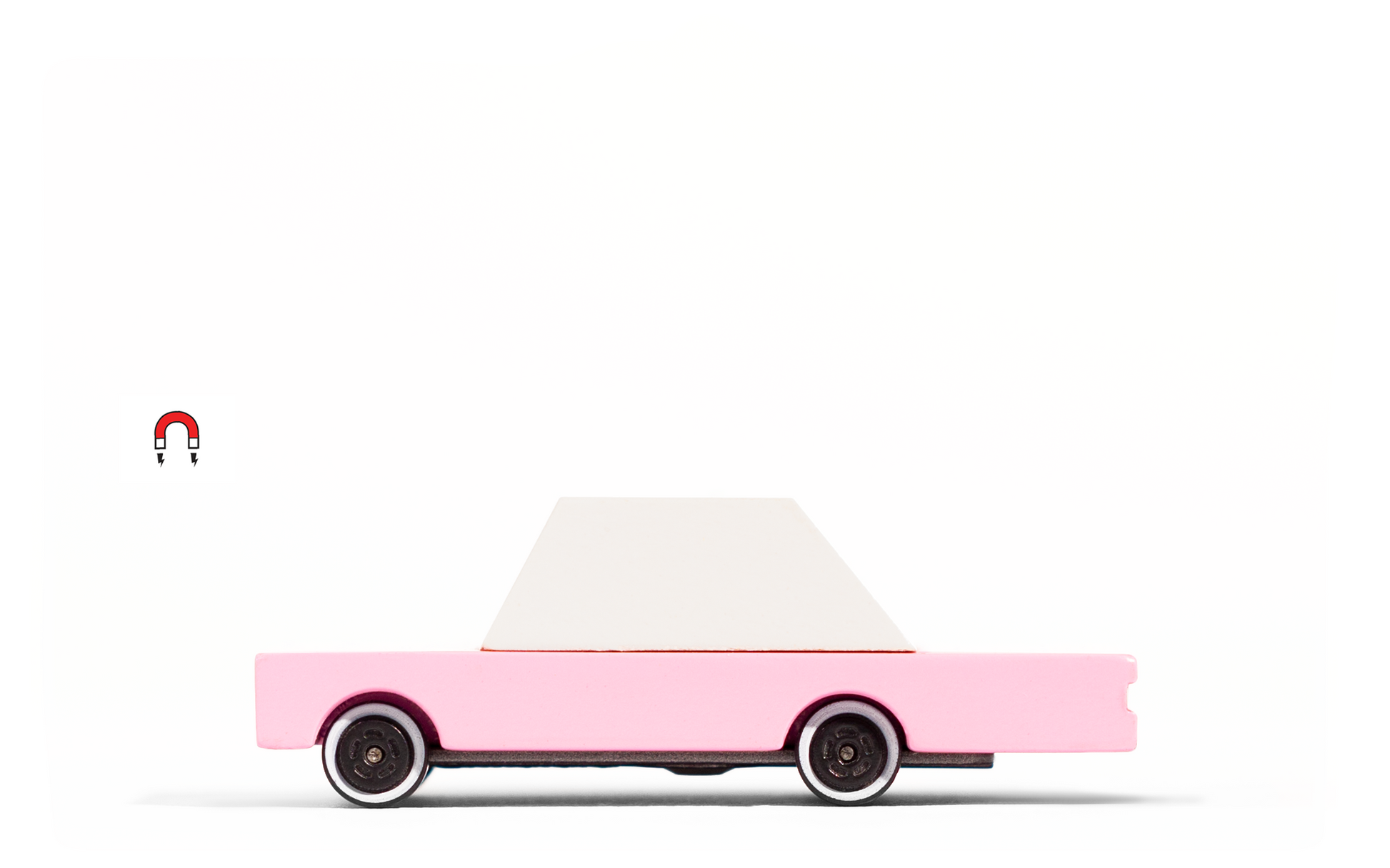 Pink Sedan toy car by Candylab Toys features solid beech wood and water-based paints. Made sustainably, made to last, made for fun. Wood, soy inks, water-based paints, degradable rubber, and metal parts are all part of Candylab's old school way of making toys, with a modern design twist.