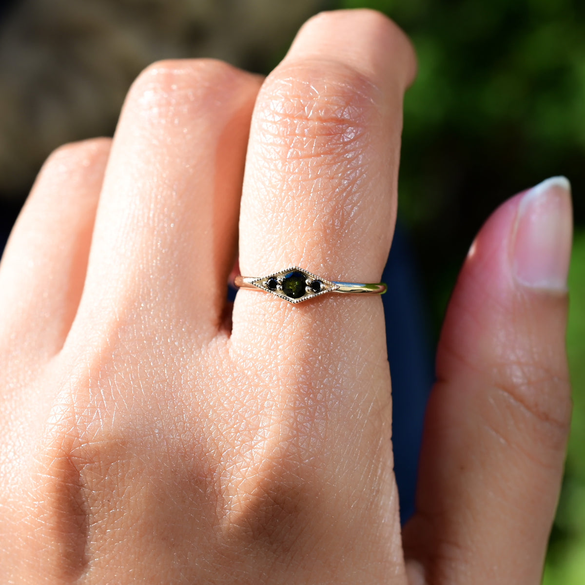 Deep blue green tourmaline encompassed in a diamond shape of solid 14k yellow gold and 2 black diamonds. A one of a kind ring inspired by an island in Scotland. Each Miarante piece is carefully handcrafted in Chicago by a skilled production team.