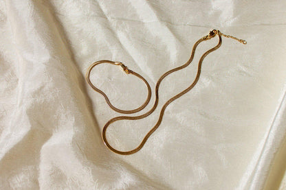 Liquid gold best describes this necklace. Flat Herringbone chain catches the light and sits on your skin in the most graceful and slinky way.  Dea Dia sold at Thread Spun.