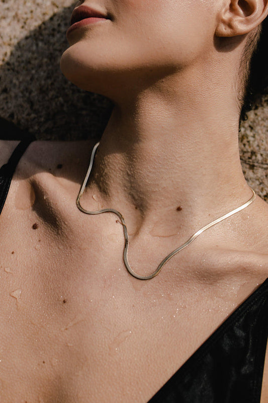 Liquid gold best describes this necklace. Flat Herringbone chain catches the light and sits on your skin in the most graceful and slinky way.  Dea Dia sold at Thread Spun.