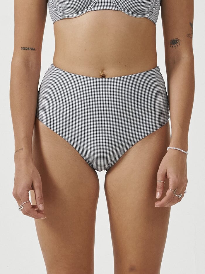 Stay stylish and eco-friendly with the Paradise Cove high waist bikini bottom in a micro check pattern. Made from recycled polyester, this piece features a high waist design for ample coverage and a timeless look. Designed in Byron Bay, Australia.