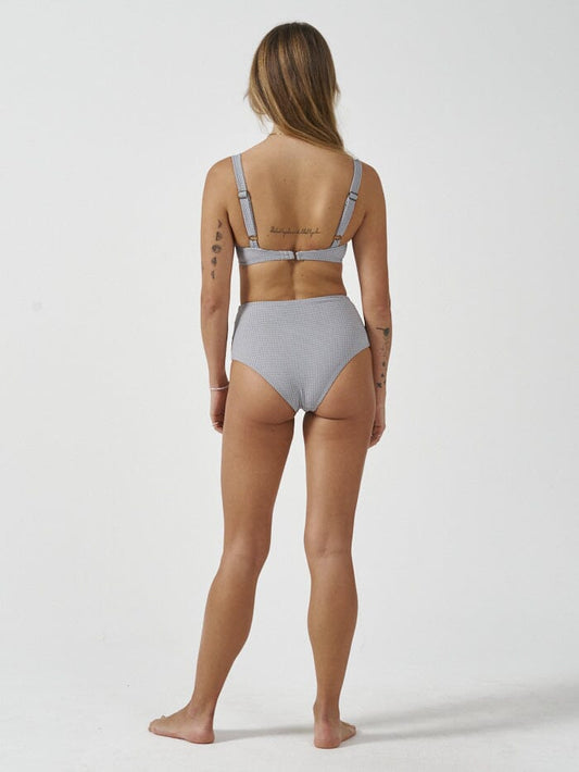 Stay stylish and eco-friendly with the Paradise Cove high waist bikini bottom in a micro check pattern. Made from recycled polyester, this piece features a high waist design for ample coverage and a timeless look. Designed in Byron Bay, Australia.