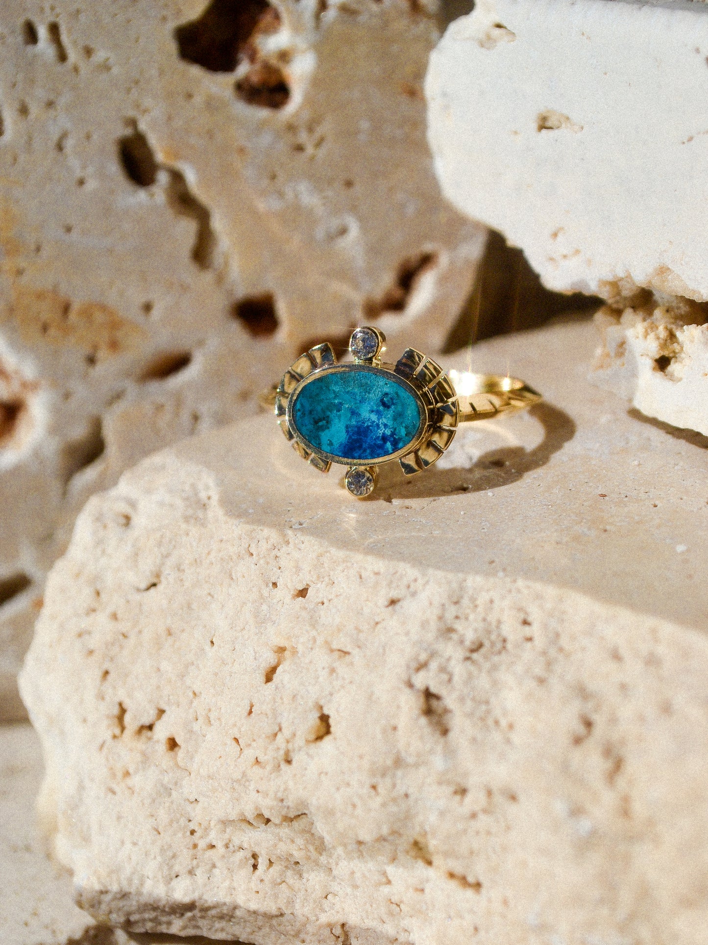 young in the mountains /  The Sol Ring features inlaid shattuckite and is a beautiful and classic Young in the Mountains style. The Sol ring features two .03 ct. reclaimed white diamonds bezel set in 14k gold at top and bottom with golden wings at each side.