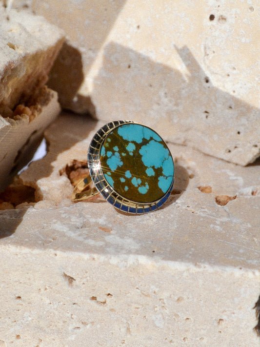 TIDEPOOL RING BY YOUNG IN THE MOUNTAINS / A beautiful #8 Turquoise wrapped in 14k recycled yellow gold and surrounded by a serrated recycled sterling silver bezel. The 14k yellow gold Helena ring band features hand carved grooves on a triangle band. The stone is ethically-mined in Nevada.