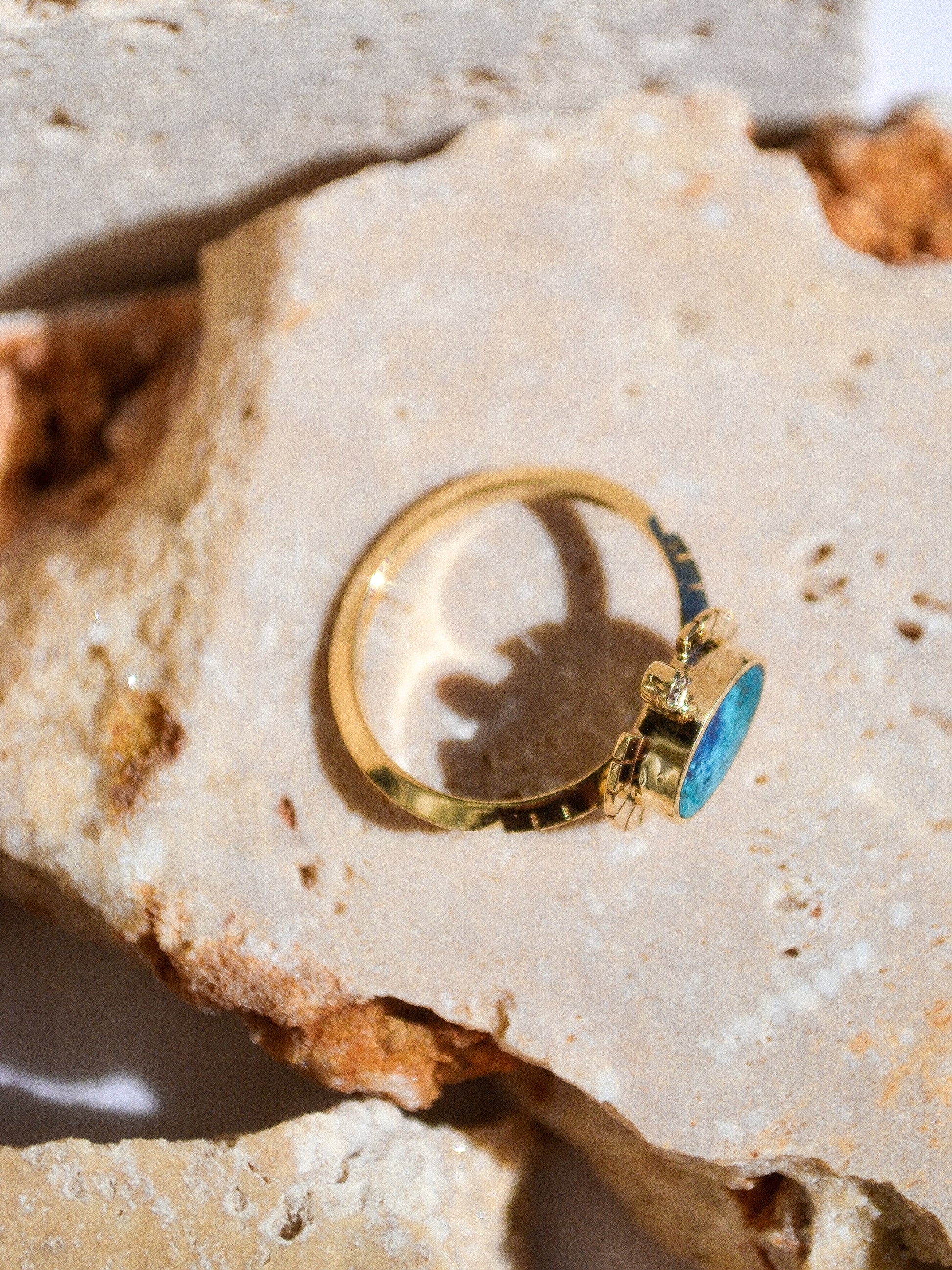 young in the mountains / The Sol Ring features inlaid shattuckite and is a beautiful and classic Young in the Mountains style. The Sol ring features two .03 ct. reclaimed white diamonds bezel set in 14k gold at top and bottom with golden wings at each side