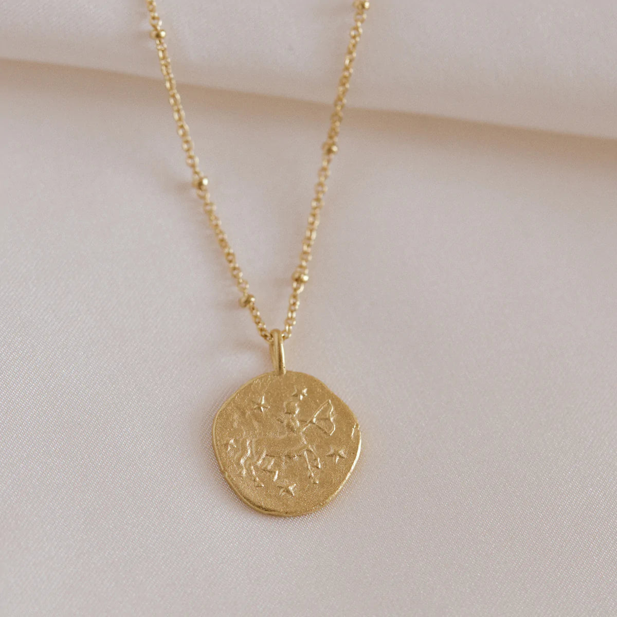 Sagittarius reflects a unique personality with their loyalty, assertiveness and compassion. Show your true self set in gold. 24K sustainable gold plated pendant and chain ethically made in France in Agape Studio's Parisian workshop. 