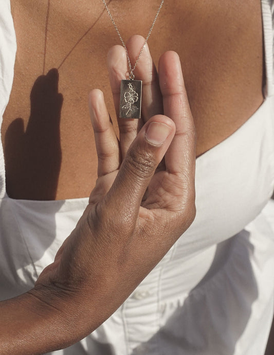 Handmade bronze tarot necklace featuring a wild rose. A tarot card from the plant world to adorn your neck. Hand carved in wax from original drawings by Arwyn Moonrise and sustainably made in northern California by Amanda Hunt.