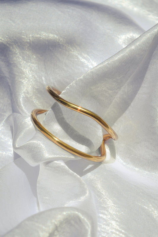 A flowing open cuff inspired by the arroyos of the high desert. Hand cast bronze made by Amanda Hunt.