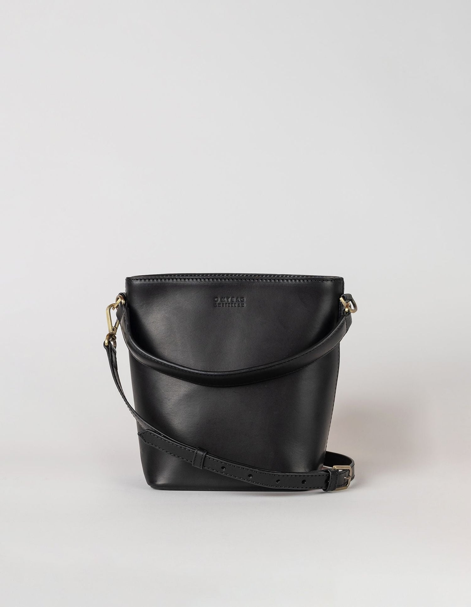 This classy bucket bag has one roomy interior and a slip-in pocket to grab your small essentials in a sec. Designed with a flat bottom, Bobbi stands on her own, making a true statement. Carry her with the top handle or wear her as a cross body bag. Made in India.