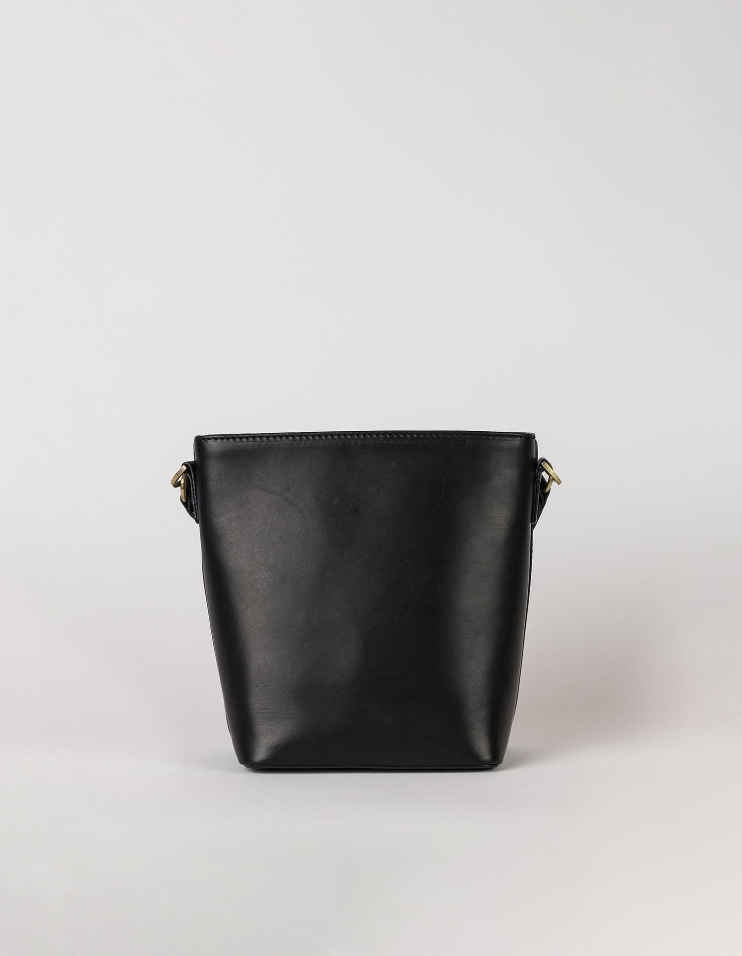 This classy bucket bag has one roomy interior and a slip-in pocket to grab your small essentials in a sec. Designed with a flat bottom, Bobbi stands on her own, making a true statement. Carry her with the top handle or wear her as a cross body bag. Made in India.