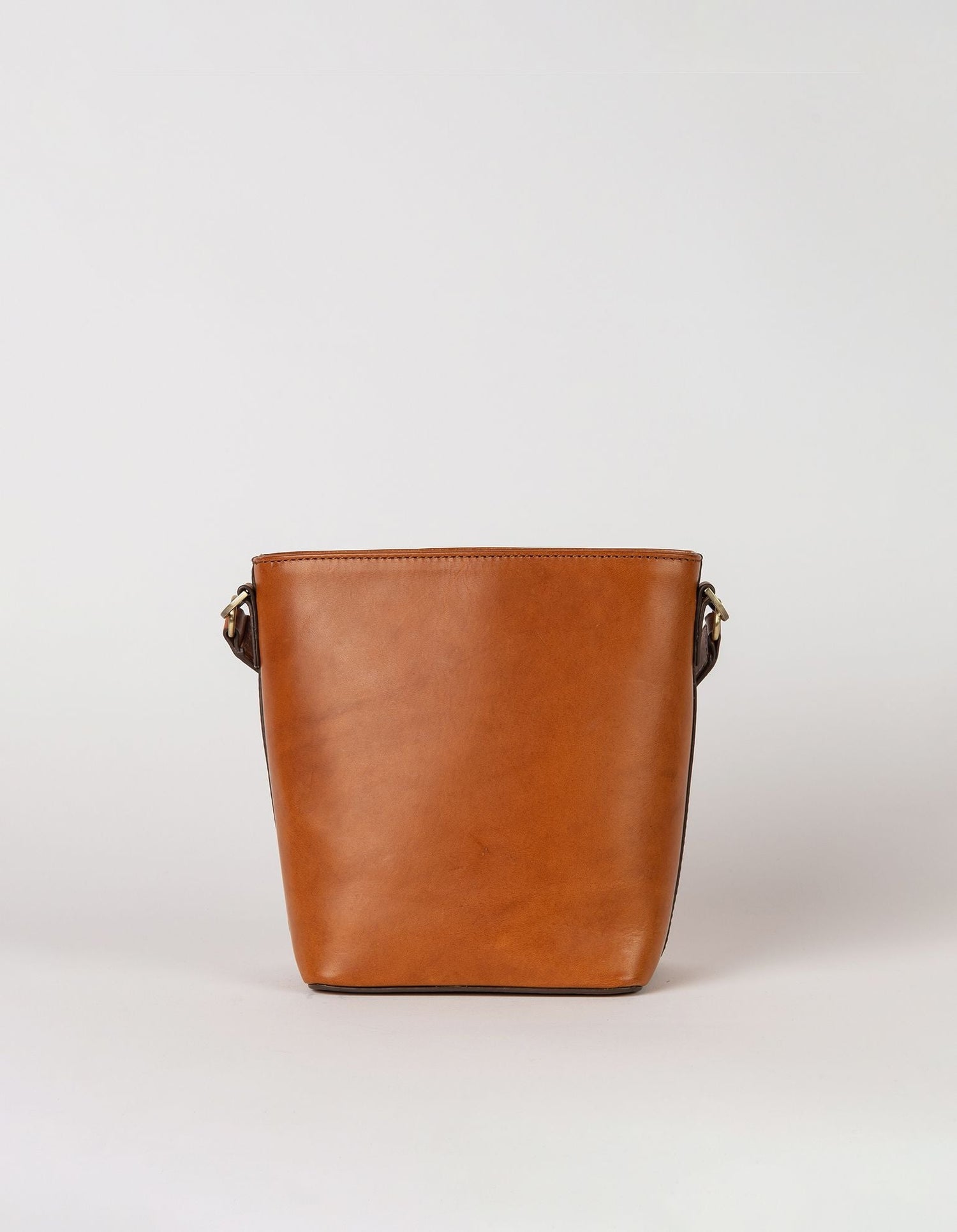 This classy bucket bag has one roomy interior and a slip-in pocket to grab your small essentials in a sec. Designed with a flat bottom, Bobbi stands on her own, making a true statement. Carry her with the top handle or wear her as a cross body bag. Made in India.