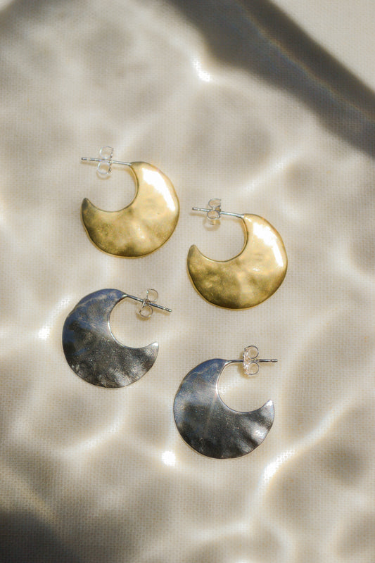 Bora Hoops by Amanda Hunt. A smooth yet slightly textured hoop. Light as a feather. Available in hand cast sterling silver with sterling silver posts or hand cast yellow bronze.