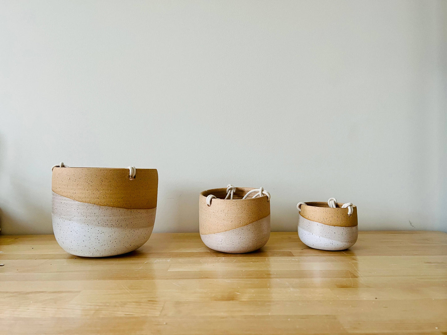 Handmade ceramic planter for your little guys in the home. Earth tone clay with a natural glaze. Includes a drainage hole, cotton cord, and 1" brass ring.