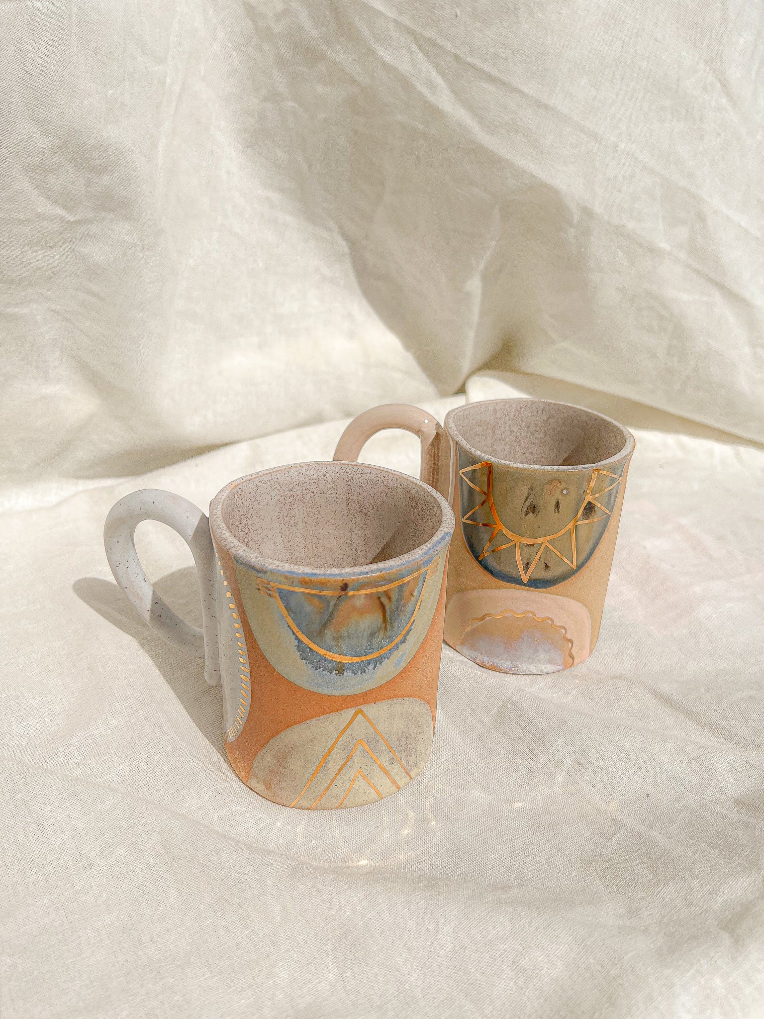 Handmade ceramic mug featuring unique glaze colors and a looped handle.