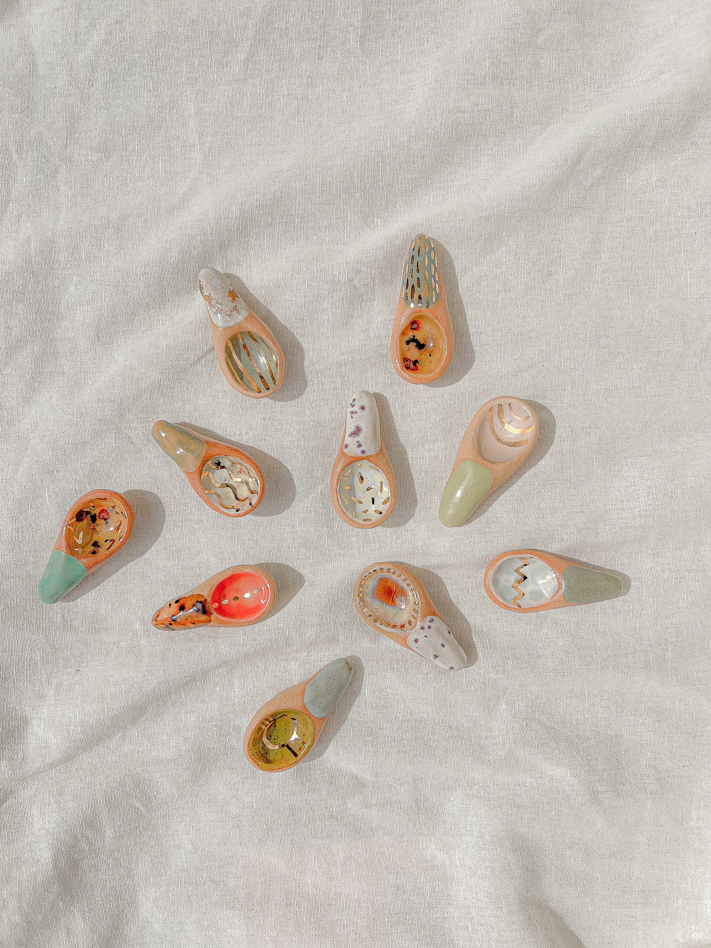 Handmade ceramic sugar spoons that are as sweet and colorful as the sugar (or any other spice) you can scoop with them! These make a great gift. Each is entirely one of a kind featuring fun designs and colors.