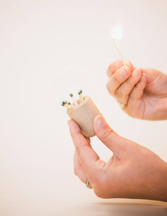 A small stoneware cylindrical match holder to perfectly accompany any candle. The surface of this piece also doubles as a match striker when using “strike anywhere” matches. All Jars of Dust pieces are handcrafted with great care in their Virginia Beach, VA studio from start to finish. 