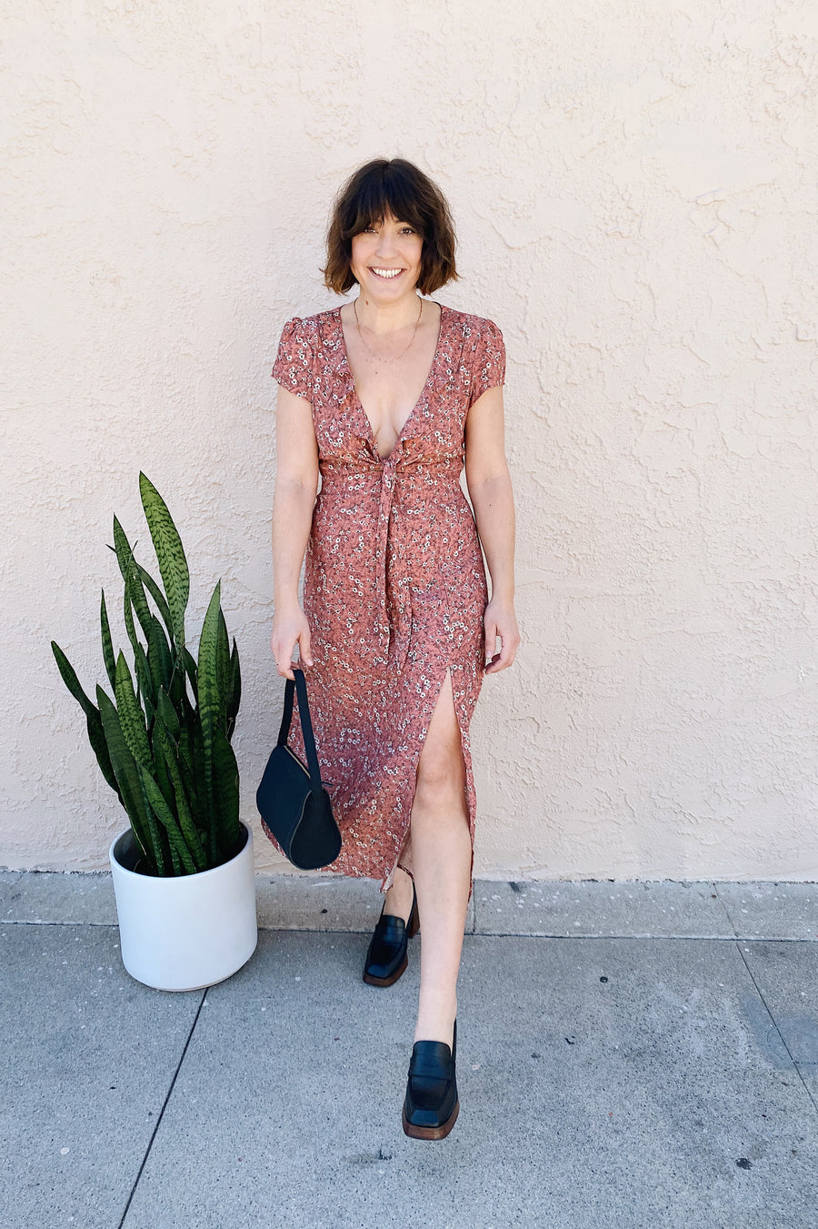 The Bree dress is not only versatile, but she’s a tad bit sexy with a leg slit and cut-out detailing on the front and back. Midi length featuring a tie front and ruffled details. Made in Los Angeles.
