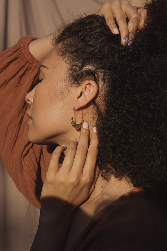 The Muse Hoops handmade with sterling silver by Amanda Hunt in Northern California. Elegant hoop earrings honoring the female form. Simple hook closure at back for continuous loop.