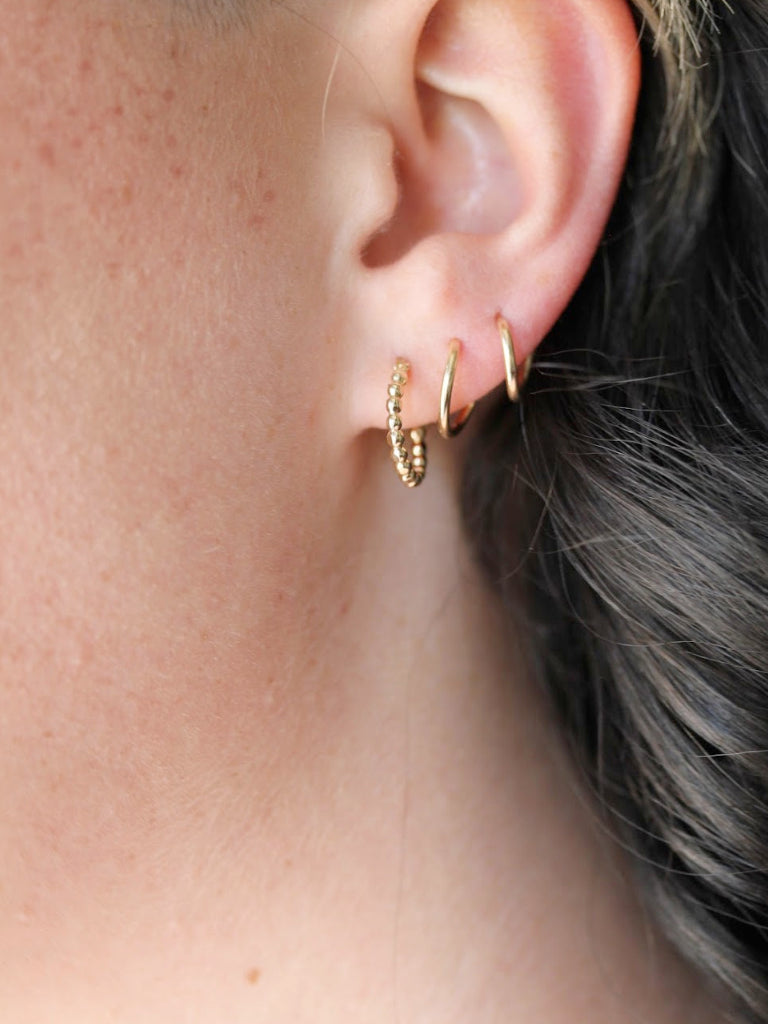 Multi faceted gold hoops catch the light perfectly to spice up your everyday look.