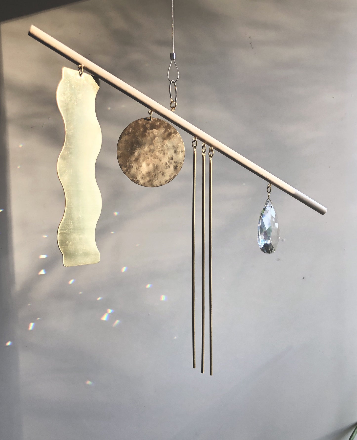 Goldy Sun Catcher - Artisan-crafted sun catcher made from raw wood, hand-cut, brushed/hammered brass sheet and vintage faceted crystal. Ready to hang in any space in your home - on a wall to brighten or in a window to catch the light.