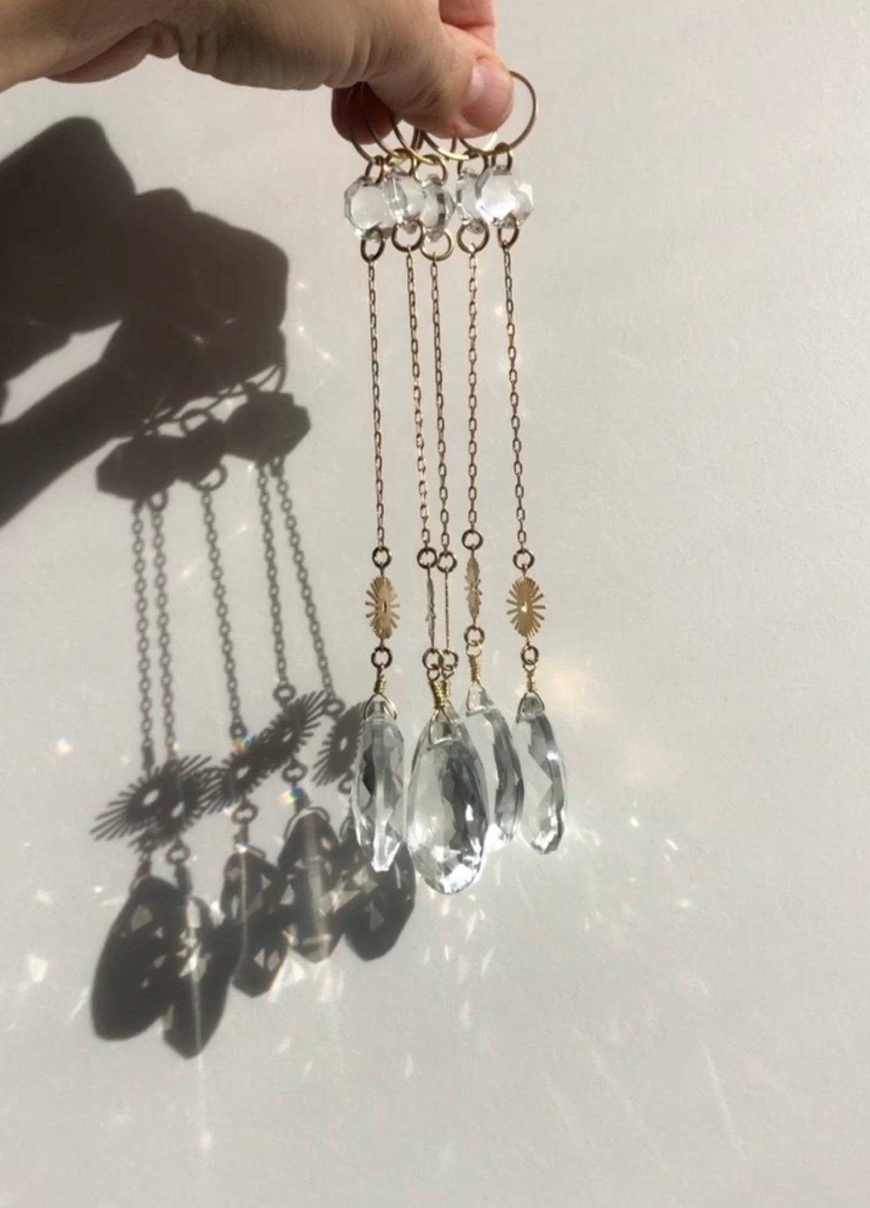 Add some magic to your drive! Artisan-crafted mini sun catcher perfect for your car or other small space. Made from brushed brass sheet, chain and vintage faceted crystals. Ready to hang. 