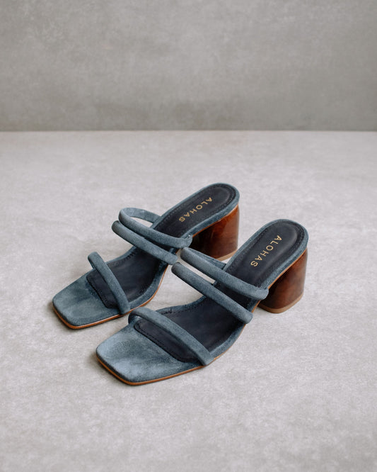 The Indiana Gray are the staple of the summer season. Defined by a minimalistic and timeless design, these suede sandals feature a curved block heel, one strap at the front and two parallel straps between the ankle and the instep, as well as a square toe for maximum flattery.