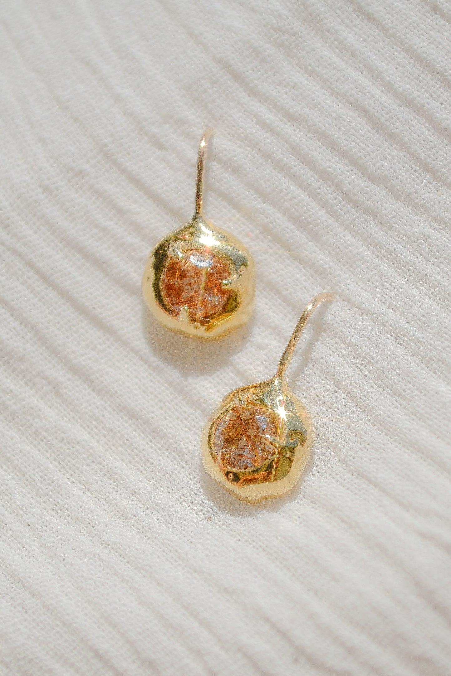 Delicate quartz pendant earrings handmade in northern California by Amanda Hunt. Keep the energy of quartz close to you.