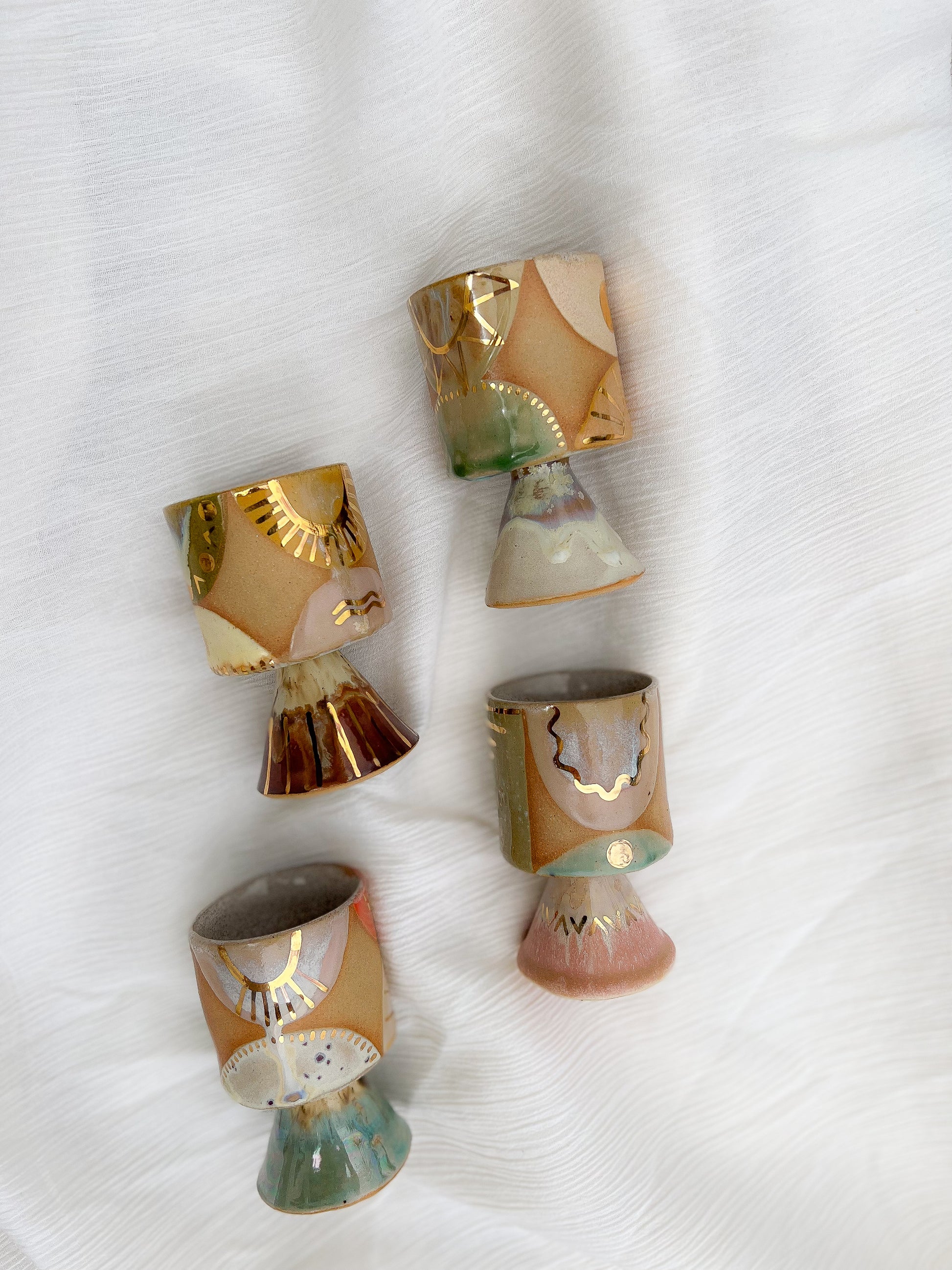 Handmade ceramic mug with stem that is just perfect for all of your entertaining needs (including cocktails). Features gold luster accents for all of your celebrations and sure to impress.