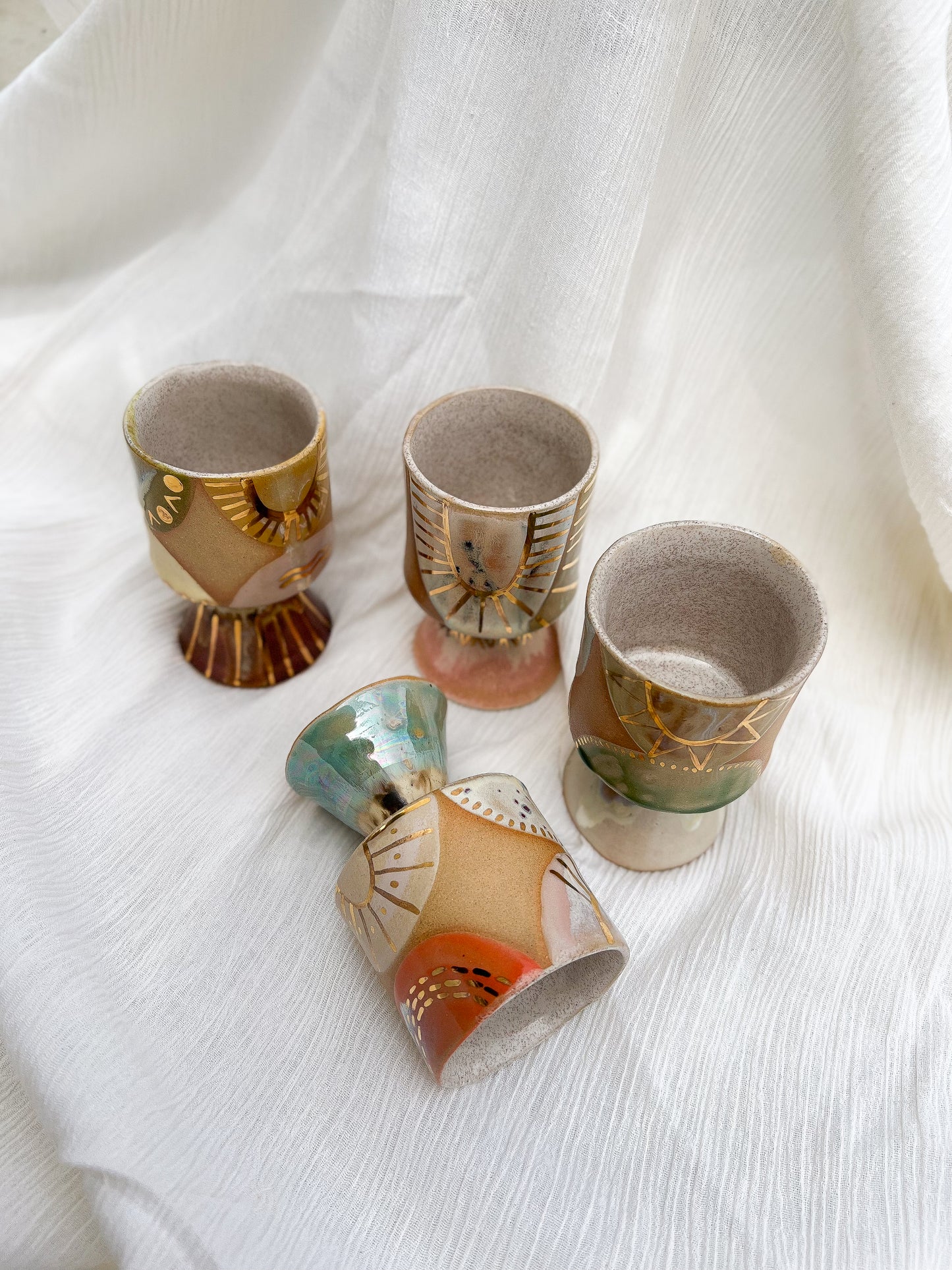 Handmade ceramic mug with stem that is just perfect for all of your entertaining needs (including cocktails). Features gold luster accents for all of your celebrations and sure to impress.