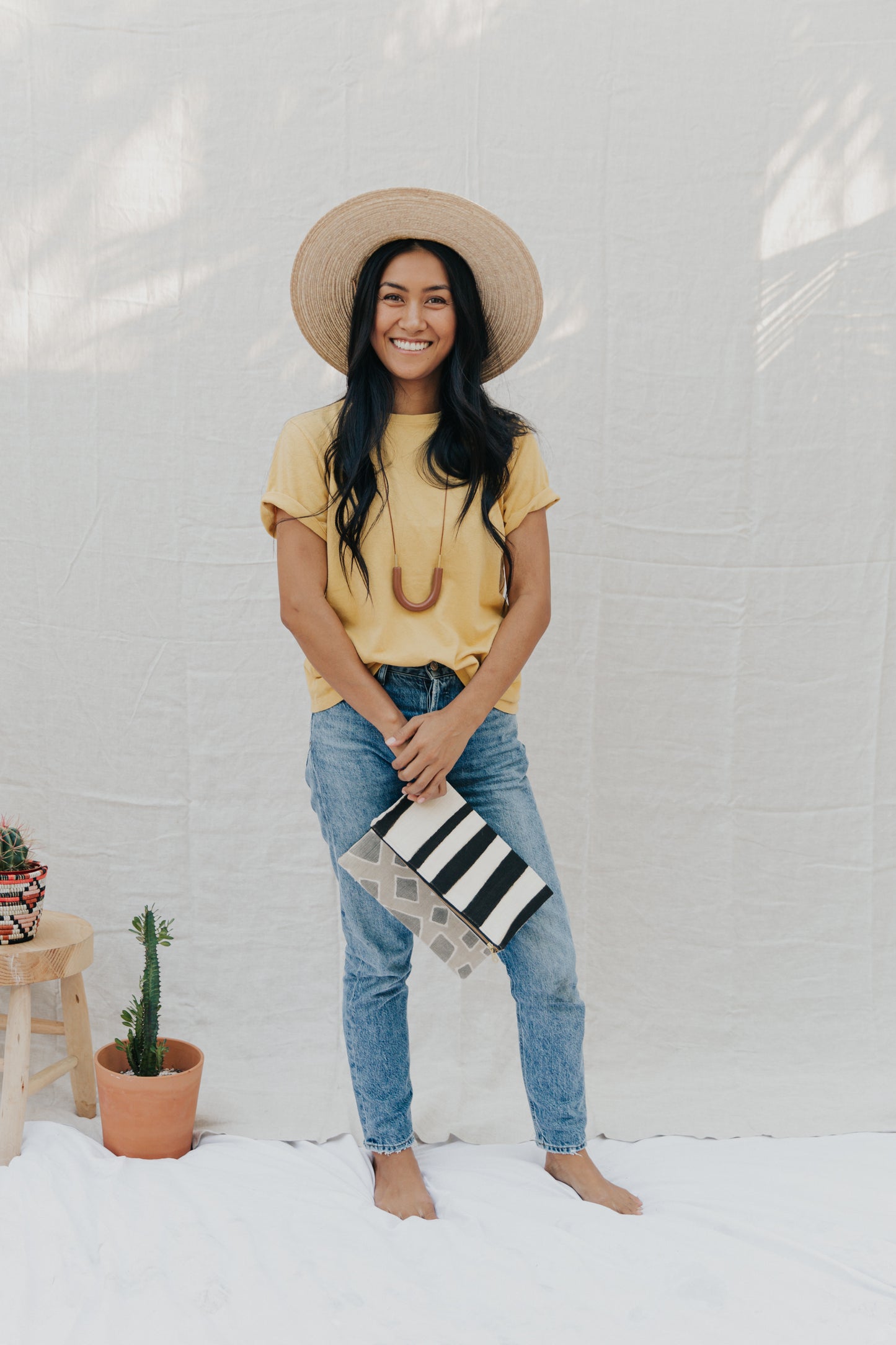 Handmade foldover/reversible clutch featuring fair trade textiles naturally-dyed by artisans from Mali. Each clutch is lined with 100% organic cotton. Sewn by our resettled refugee artisan, Lashta, locally in San Diego. Measures approximately 12" wide by 14" long when unfolded.