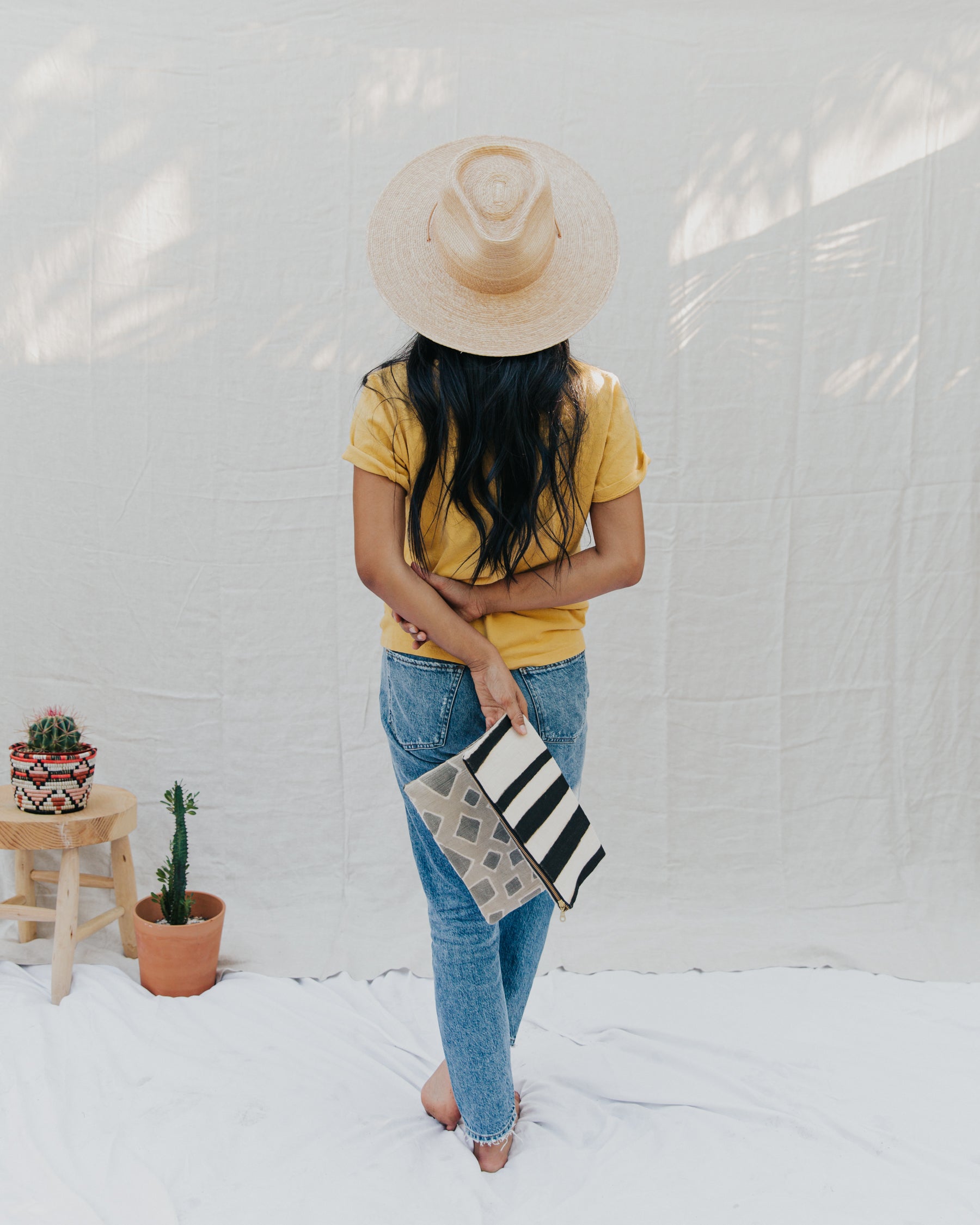 Handmade foldover/reversible clutch featuring fair trade textiles naturally-dyed by artisans from Mali. Each clutch is lined with 100% organic cotton. Sewn by our resettled refugee artisan, Lashta, locally in San Diego.