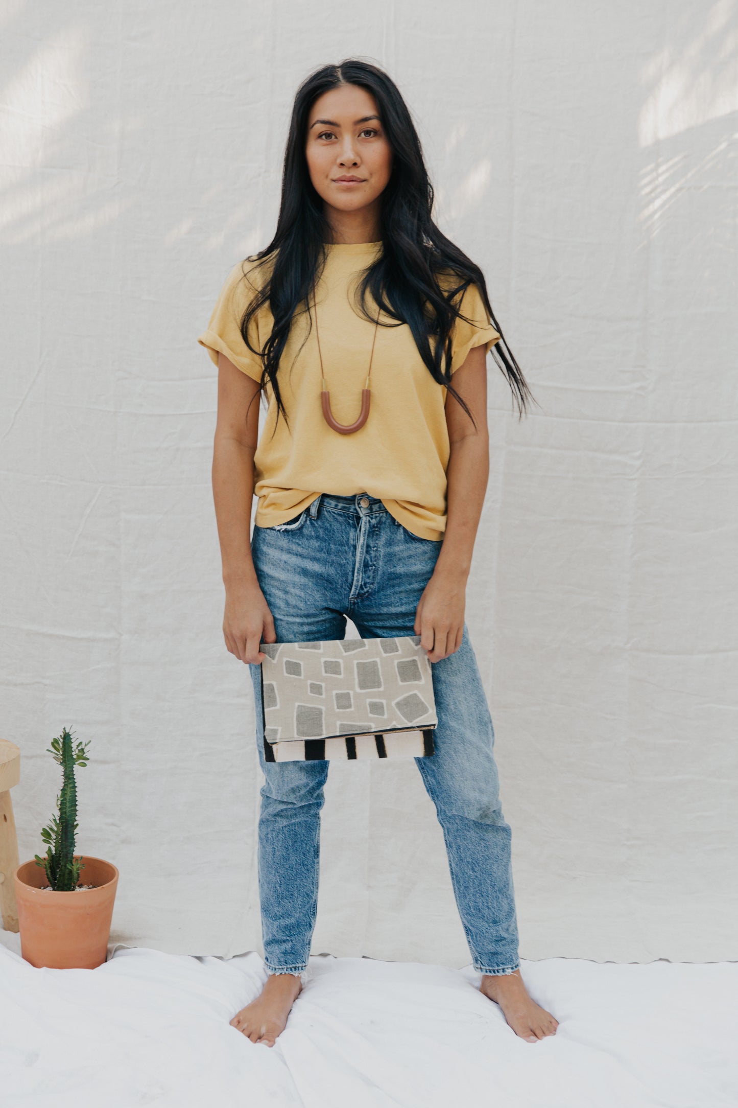 Handmade foldover/reversible clutch featuring fair trade textiles naturally-dyed by artisans from Mali. Each clutch is lined with 100% organic cotton. Sewn by our resettled refugee artisan, Lashta, locally in San Diego.