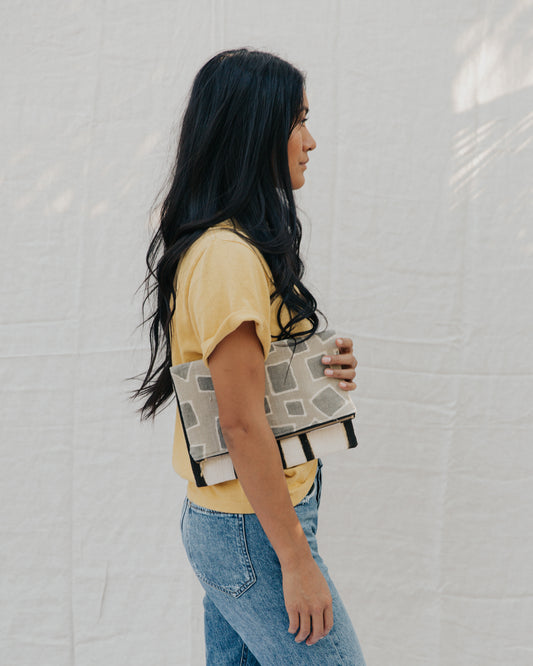 Handmade foldover/reversible clutch featuring fair trade textiles naturally-dyed by artisans from Mali. Each clutch is lined with 100% organic cotton. Sewn by our resettled refugee artisan, Lashta, locally in San Diego.