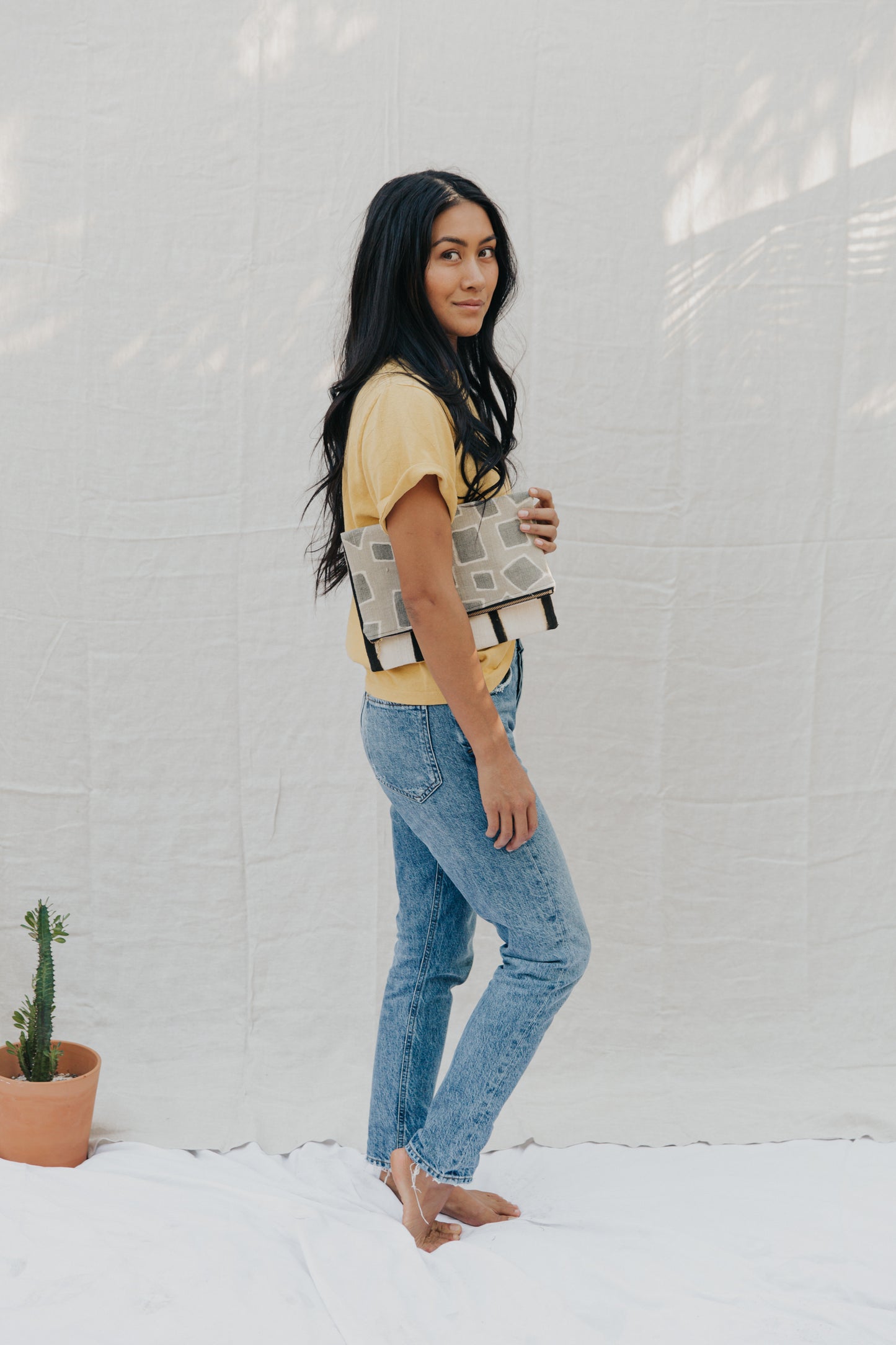 Handmade foldover/reversible clutch featuring fair trade textiles naturally-dyed by artisans from Mali. Each clutch is lined with 100% organic cotton. Sewn by our resettled refugee artisan, Lashta, locally in San Diego. Measures approximately 12" wide by 14" long when unfolded.