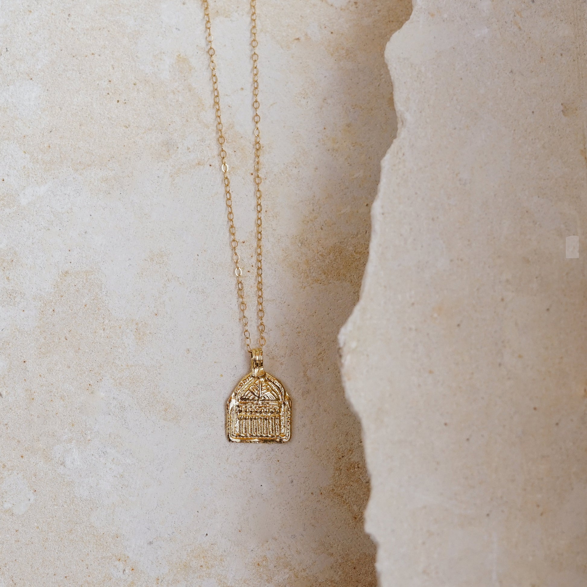 Janus Necklace by Mountainside Jewelry. Delicate light weight hand carved charm necklace designed to represent a door, passageway or opportunity. Recycled brass pendant coated in a thick layer of high grade 14k gold. Handmade in the Santa Cruz Mountains.