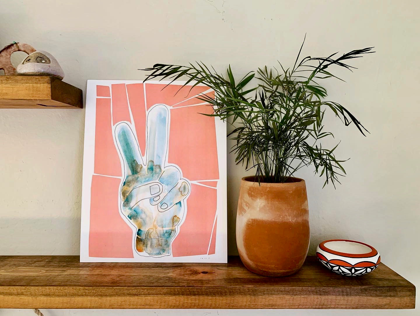 Print of an original watercolor by local Encinitas, California artist, Tait Hawes. Measures 11" x 17" and features peace fingers in peaches and blue tones.