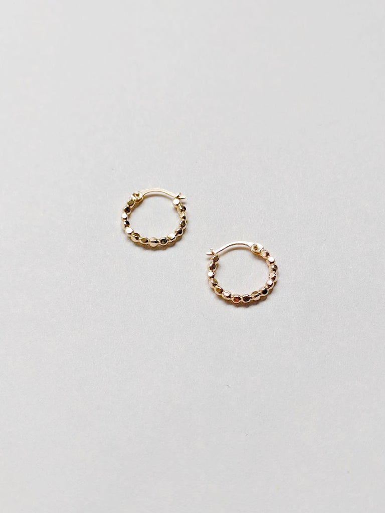Multi faceted gold hoops catch the light perfectly to spice up your everyday look.