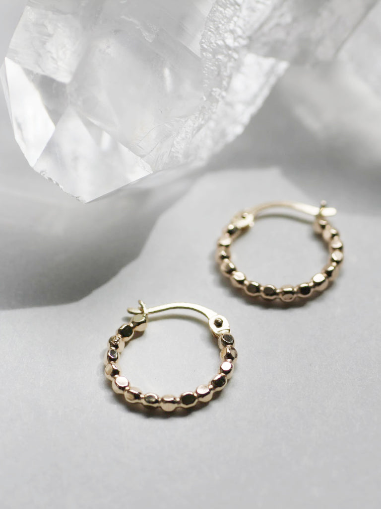 Multi faceted gold hoops catch the light perfectly to spice up your everyday look.