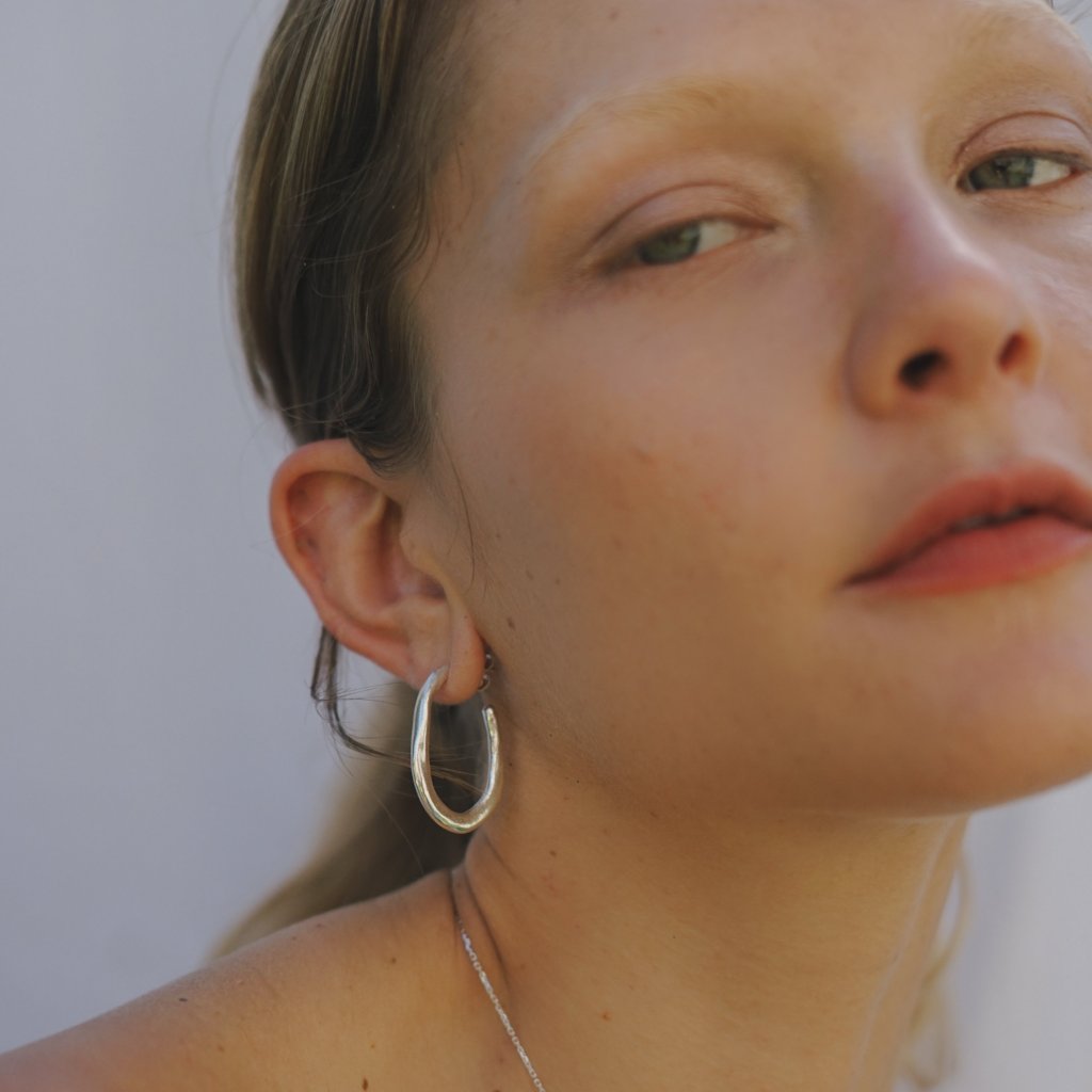 Amanda Hunt Lake Hoops The perfect everyday hoop inspired by the organic shape of lakes. Hand cast in Sterling Silver.