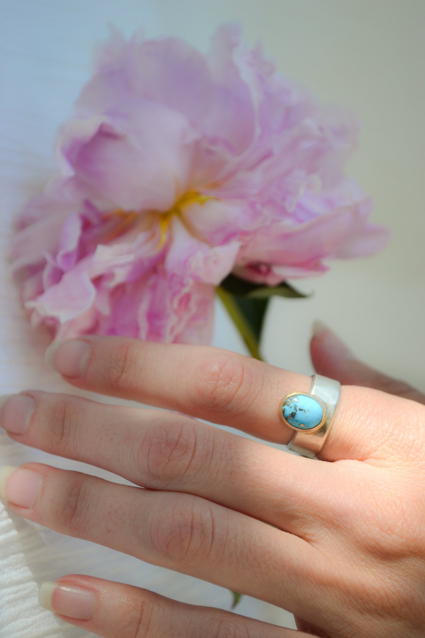 Made by hand in Northern New Mexico using recycled metals and responsibly sourced stones. This ring features a large cabochon Persian Turquoise stone set in a 14k yellow Gold bezel on a wide Sterling Silver band with matte finish. Mesa Ring by Halcyon Jewelry.