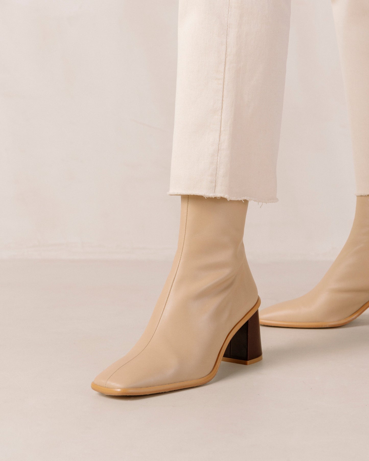 If you don’t know where to go, go West. These sustainable beige boots set atop a contrast block heel, with a slim line silhouette. Defined by their stone wash & square toe, these leather ankle booties also have inward facing zippers for extra comfort and feature a flattering, slim fit.